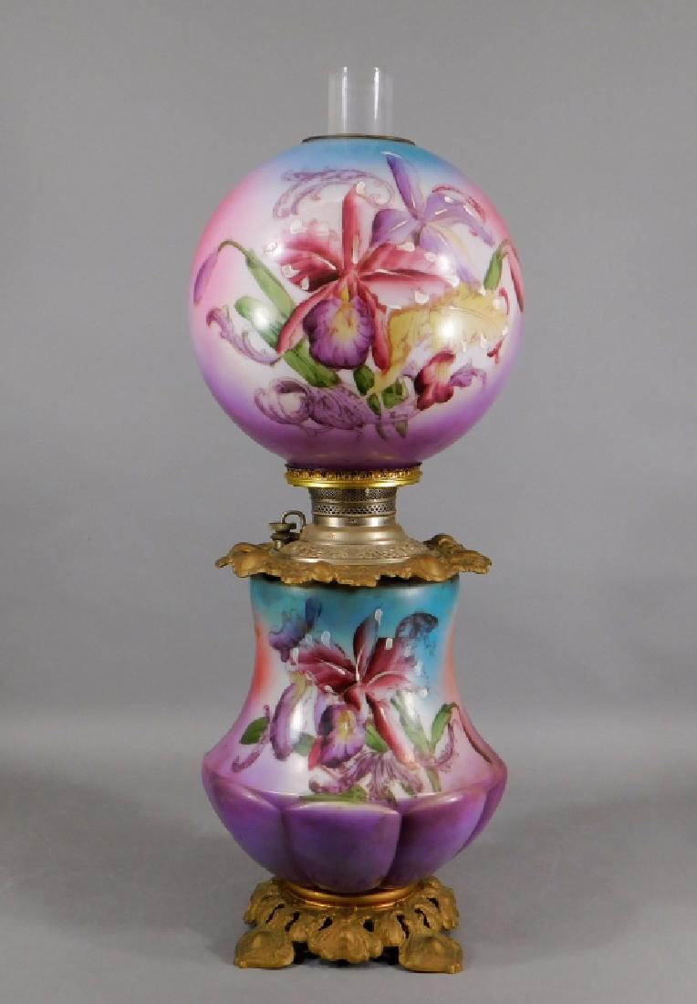 19C. Miller Gone With The Wind Glass Oil Lamp: ,Connecticut,19th Century Lobed vasiform base with embossed brass mounts decorated with lavender flowers supporting a matching globe shade. Brass, glass,27" to top of chimney, Marked "The Miller Lamp