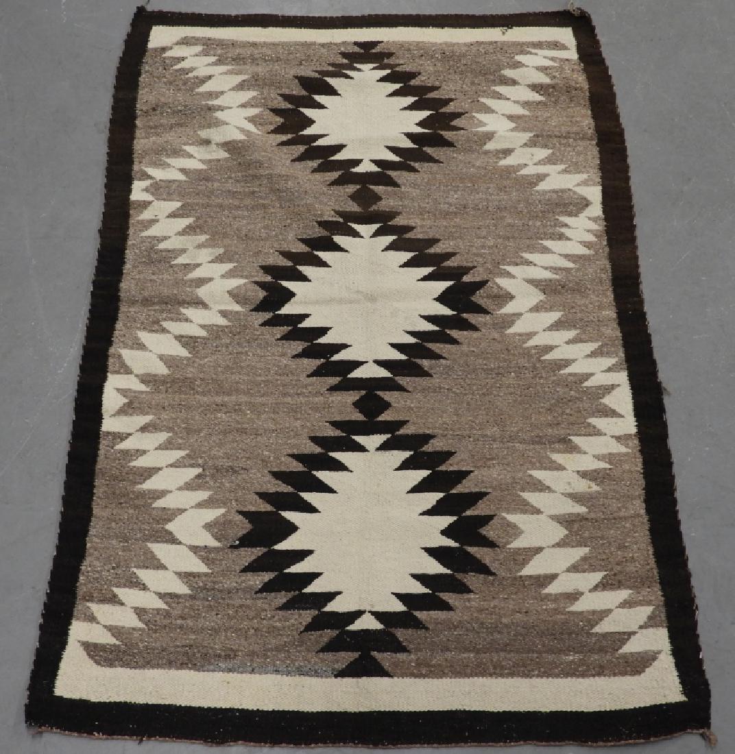 Native American Navajo Indian Eye Dazzler Rug: ,Native American,Early to mid 20th Century A simple central sawtooth pattern with ivory and brown border. Wool,4' 2" x 2' 10",