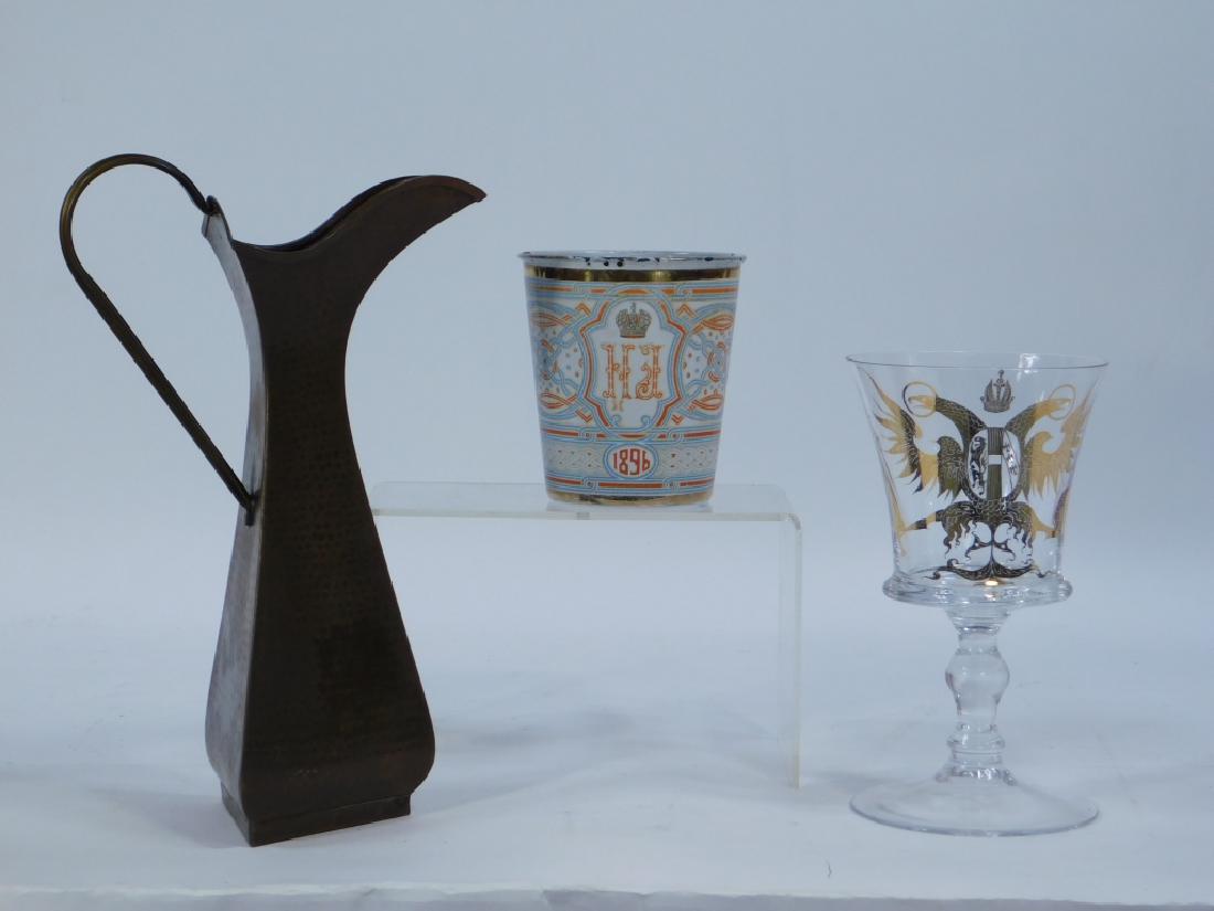 3PC Russian Nicholas II Coronation Glass Group: ,Russia,Late 19th-Early 20th Cenutry Group includes an enameled glass Tsar Nicholas II coronation cup, a hammered copper pitcher, and a double headed eagle gilt wine glass. All three articles are mark