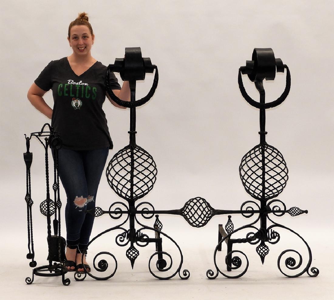 LARGE PR Wrought Iron Andirons Fireplace Tool Set: United States,20th Century Massive pair of hand wrought andirons with curled scrolled top and heavy swag handles over heavy shaft with twisted bulbous central section over scrolled base. Retains conne