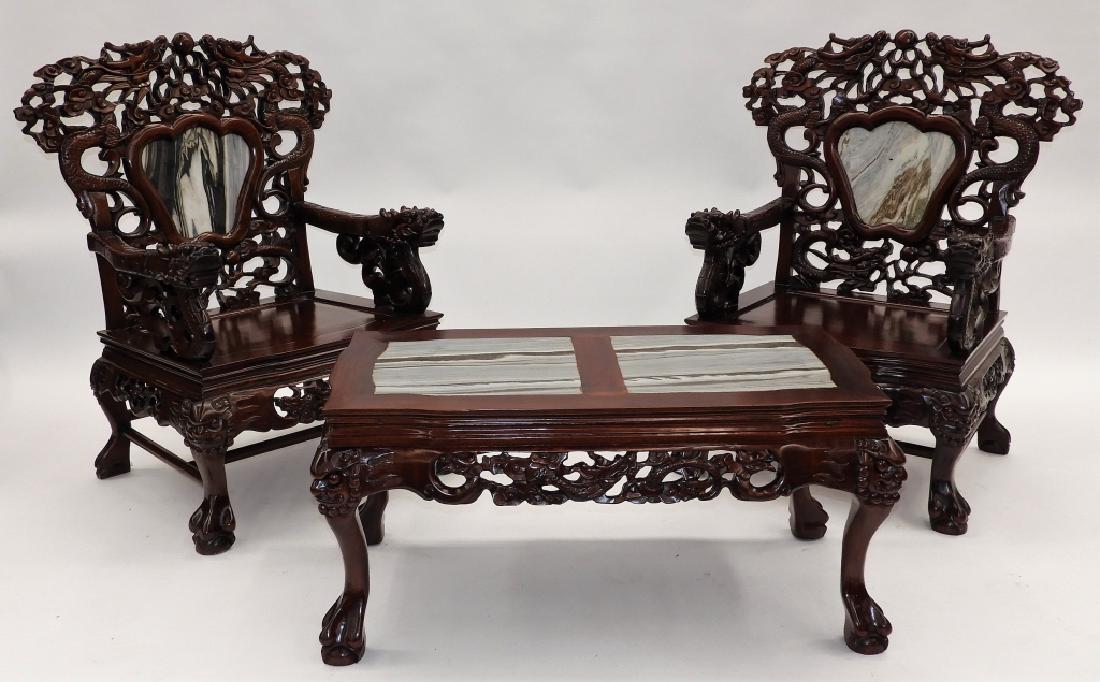PR Chinese Carved Hardwood Marble Chairs & Table: China,20th Century Chairs carved with dragons chasing a pearl amongst clouds with a marble mountain scene tile inset over a hardwood solid seat flanked with arms terminating into dragon heads on an or