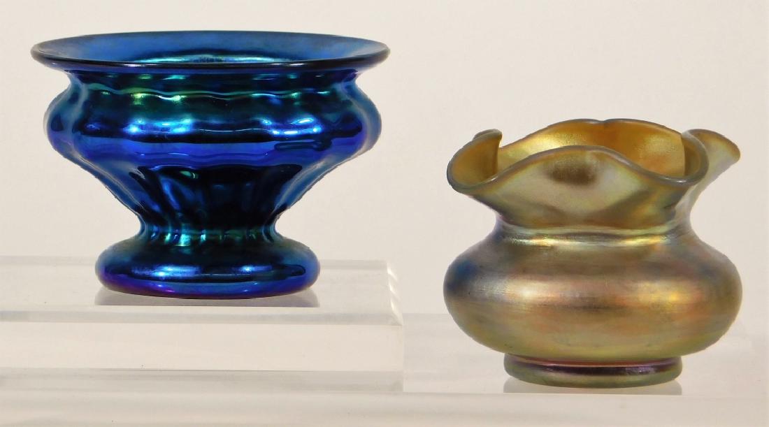 2 Steuben Aurene & Lundberg Art Glass Salt Cellar: United States,20th Century Group includes a Steuben Aurene ruffled salt cellar and a contemporary Lundberg Studios iridescent blue salt cellar. Glass,Lundburg 1 7/8" tall,Steuben 1 3/4" tall Blue cell