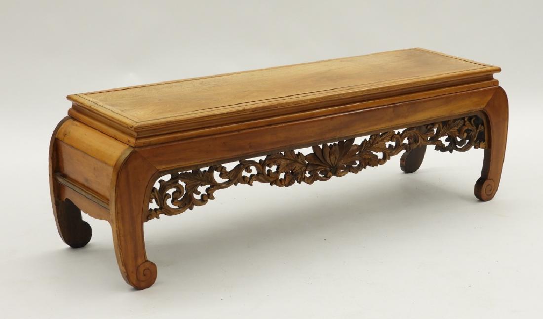 Chinese Carved Hardwood Long Kang Table Bench: China,20th Century Nicely figured wood plank upon a floral apron base. Hardwood,18" t x 54" w x 16" d, From a Newport, Rhode Island lady.
