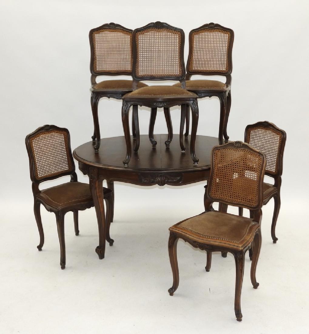 French Country Fruitwood Rococo Chairs & Table Set: France,20th Century Set includes six matching chairs with scrolled shell crest over a caned back and shaped seat supported by an acanthus leaf knee cabriole leg with whorl foot, table with matching mo