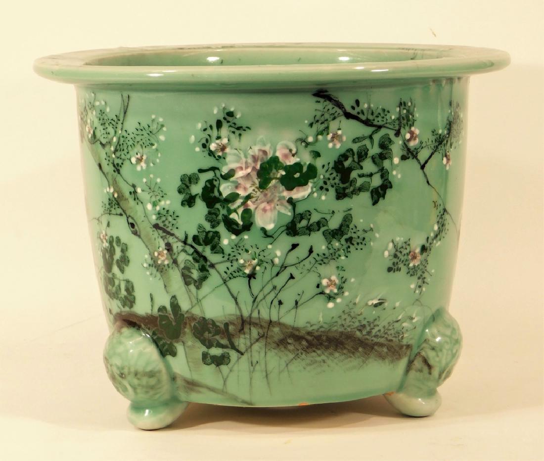 Chinese Celadon Glazed Porcelain Footed Jardiniere: China,19th-20th Century Tapered form with flared rim decorated with trees and flowers on molded elephant tripod feet. Porcelain,11 1/2" tall x 15" dia., From a West Warwick, Rhode Island estate.