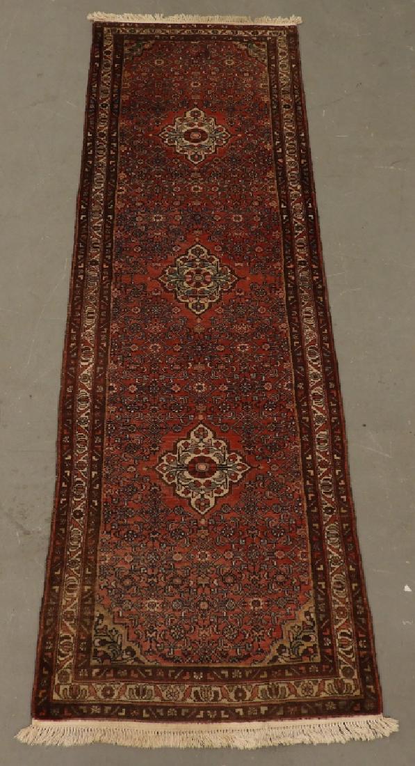 Persian Oriental Wool Carpet Rug Runner: Persia,Circa 1920 Three medallions surrounded by a red field with floral and geometric designs surrounded by a triple banded geometric border. Wool,11' 4" x 3' 7", From a Cape Cod, Massachusetts estat