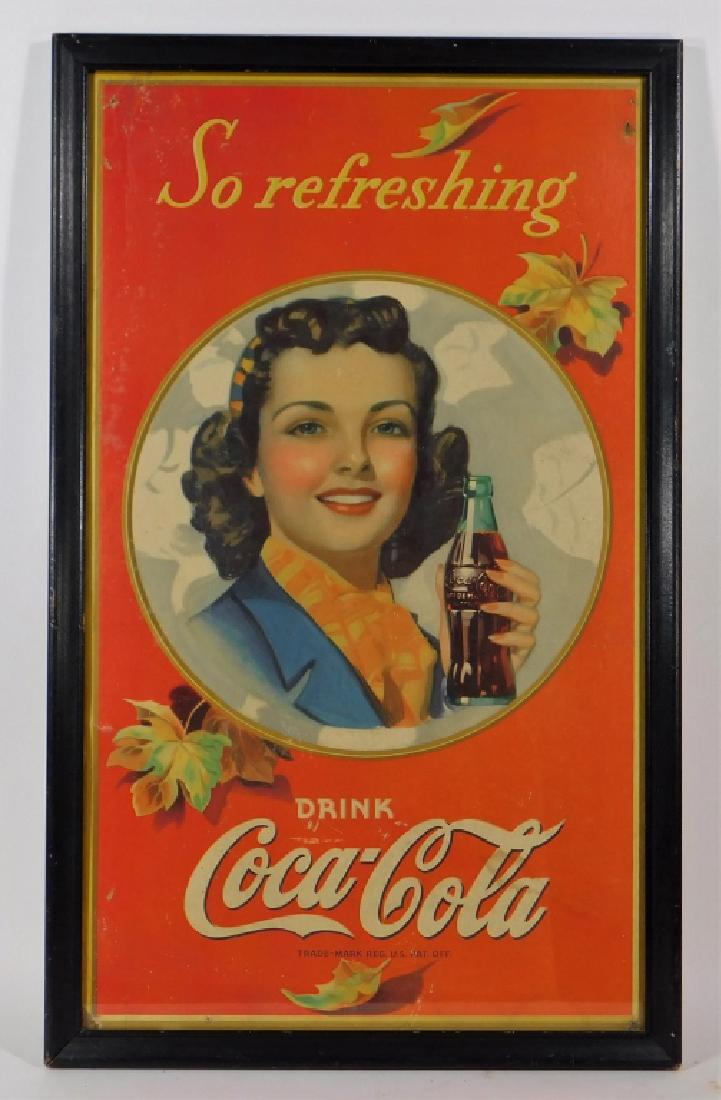 1941 Coca-Cola Cardboard Advertising Sign: United States,1941Display sign with woman in the center holding a bottle of Coke and reads "So Refreshing Drink Coca-Cola".Cardboard,28 5/8" x 17 1/2" framed,From the collection of Russell Buteau, Mil