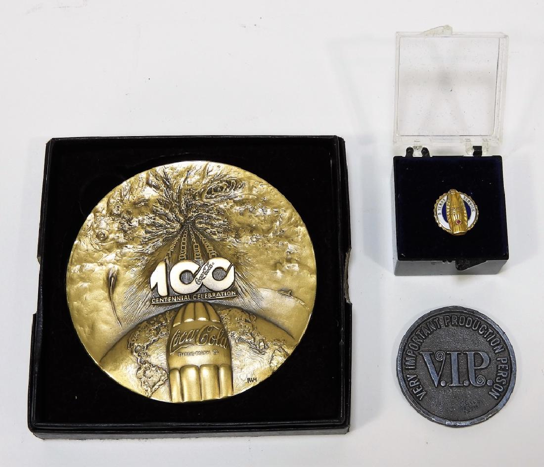 3PC Coca-Cola Bronze Medal Coin Enameled Pin Group: United States,20th CenturyIncludes a large bronze Centennial Celebration medal, Coca-Cola Bottling Co. of Chicago VIP coin, and an enameled 5 years of service pin.Metal,Largest 3" dia.,Smallest 1/2" d