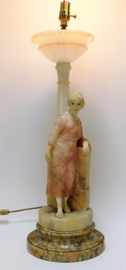 Italian Art Deco Neoclassical Woman Alabaster Lamp: ,Italy,Circa 1930 Neoclassical lamp featuring a woman dressed in a soft pink dress adorned with flowers along the bust and sleeves. Alabaster, marble,To top of alabaster 24 1/2",Overall 45 1/2" From t