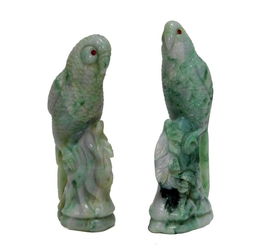PR Chinese Carved Jadeite Bird Parrot Figures: ,China,Circa 1900 Each finely carved of apple green jadeite with naturalistic feathers perched on a tree stump with foliage and inset natural ruby eyes. Jadeite,Largest 5",Smallest 4 3/8" From the col