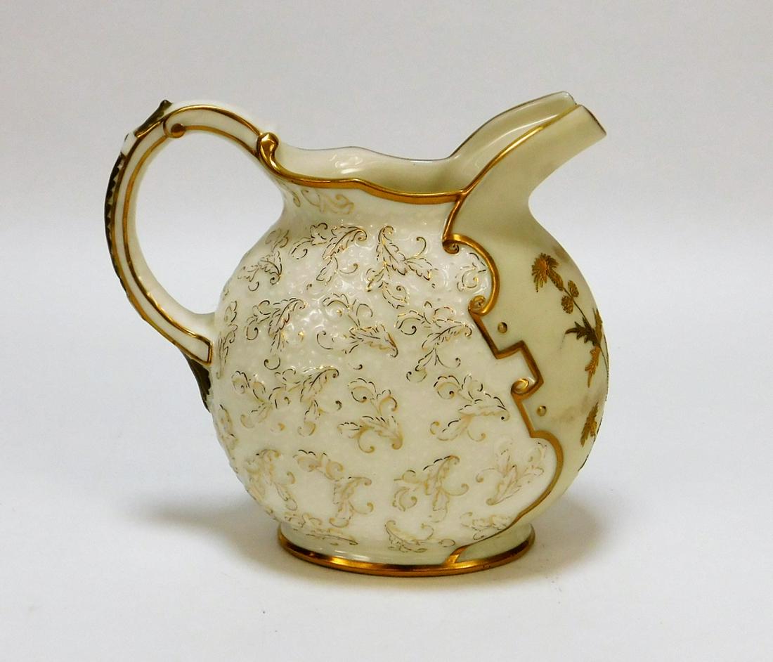 American Belleek Porcelain Thistles Leaves Creamer: ,United States,Early 20th Century Decorated with a thistle and foliate pattern with gilt accents. Porcelain,Overall 5 1/2" x 6", From the collection of a Great Neck, New York gentleman. Ott & Brewer B