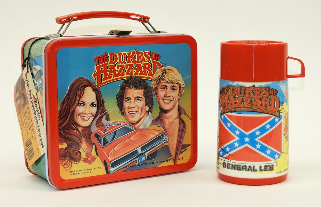 Aladdin The Dukes of Hazzard Lunch Box & Thermos: United States,1980 An Aladdin The Dukes of Hazzard metal lunch box with matching plastic thermos. Includes original Aladdin sales tag. Lunch box 8" x 7" x 3 3/4",Thermos 6 5/8" x 3 1/2" diameter