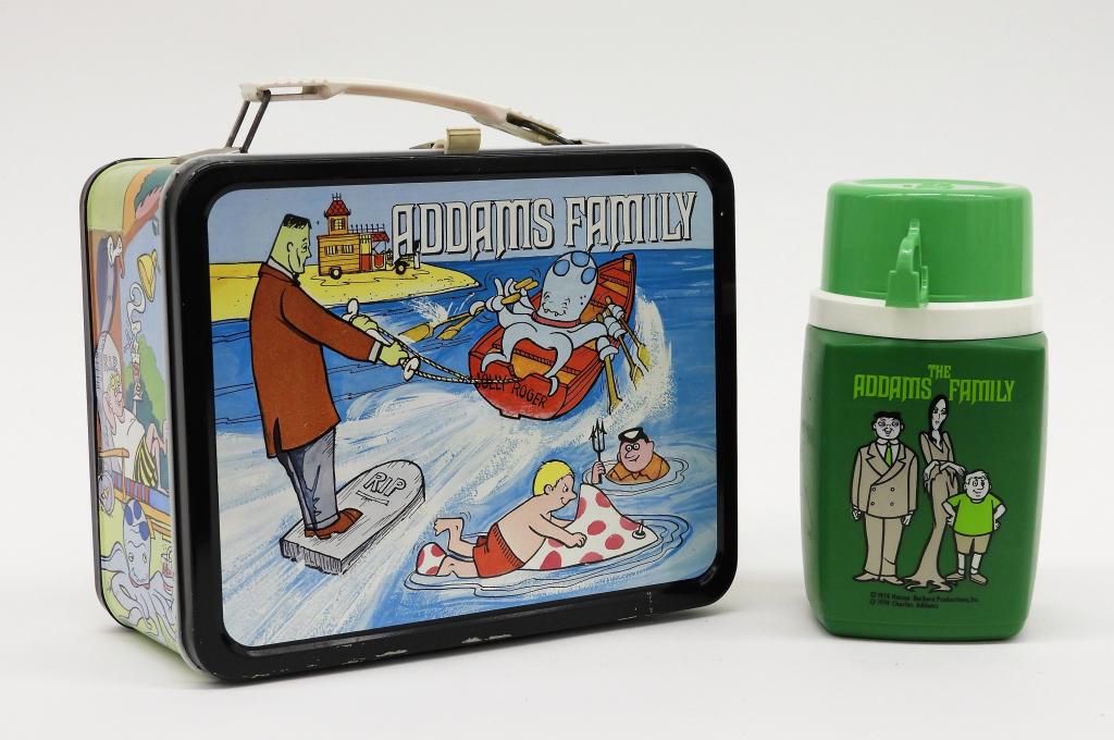 King-Seeley The Addams Family Lunch Box & Thermos: United States,1974 A King-Seeley The Addams Family metal lunch box with matching plastic thermos. Lunch box 8 3/4" x 6 7/8" x 4",Thermos 6 3/8" x 3 1/4" x 3 1/4"