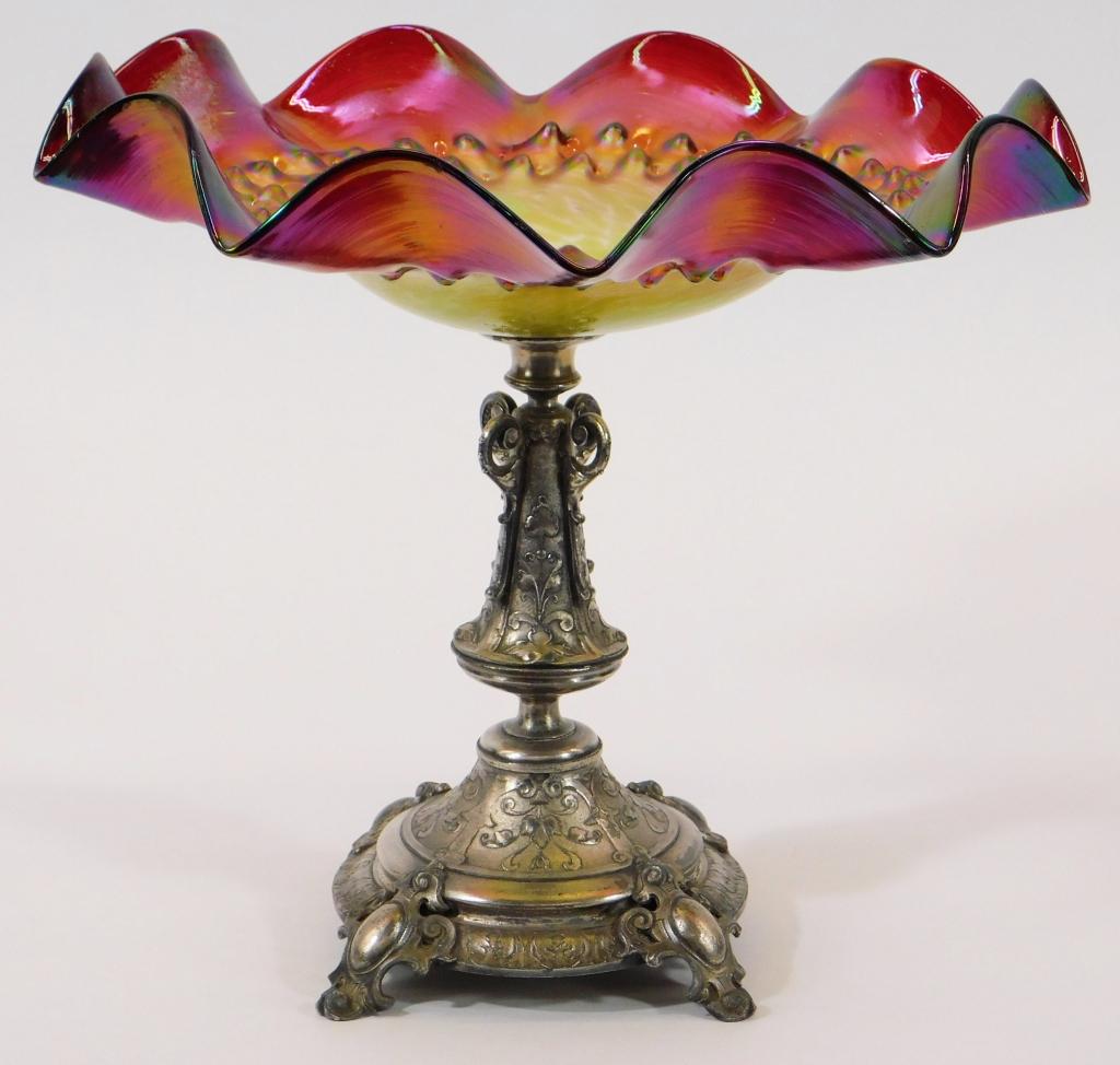 Loetz Rubina Frilled Art Glass Silver Plate Tazza: Austria,20th Century Rubina glass bowl with frilled edge and dimpled design supported by a silver plate base with Art Nouveau stylized foliage. Glass, metal,11" x 11 1/4" dia., From the collection of