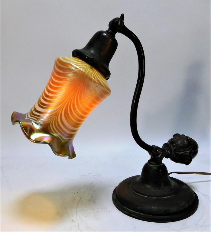 Antique BRonze Desk Lamp with Art Glass Shade: Europe,Early 20th Century Iridescent cream colored pulled feather frill shade on a curved column and simple circular base, the form giving the lamp a delicate flower shape. Metal, Glass,Overall 12 1/2