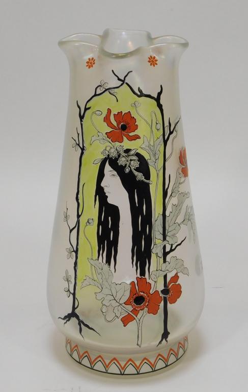 Fritz Heckert Art Nouveau Enameled Glass Vase: Bohemia,1866-1925 Ruffled iridescent vase enameled with the portrait of a Mucha-esque woman with floral headband amongst vivid orange flowers. Glass,10 1/4" x 5 1/2", Marked "F.H. 488/2 H.I." on botto