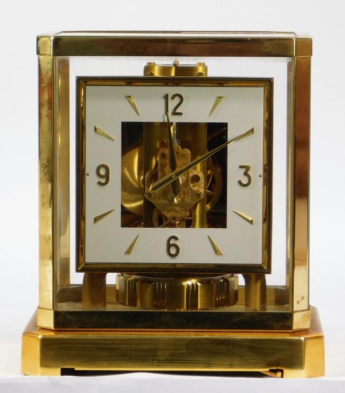 20C Swiss Jaegar LeCoultre Model 528-6 Atmos Clock: Switzerland,Circa 1970 Square white dial with raised brass Arabic numerals held within a five panel glass and brass case. Serial number 136034, model number 528-6, fifteen jewel movement. Brass, Glass