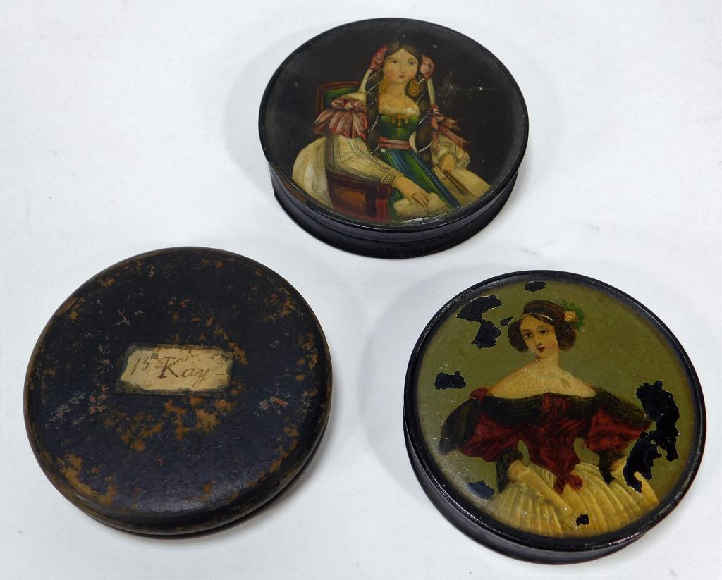 3 Antique European Painted Lady Snuff Boxes: Europe,19th-20th Century Lot includes three circular snuff boxes, two painted with elaborately dressed ladies and one plainly decorated box. Paper mache, paint,Smallest 3 1/4" dia.,Largest 3 1/2" dia.