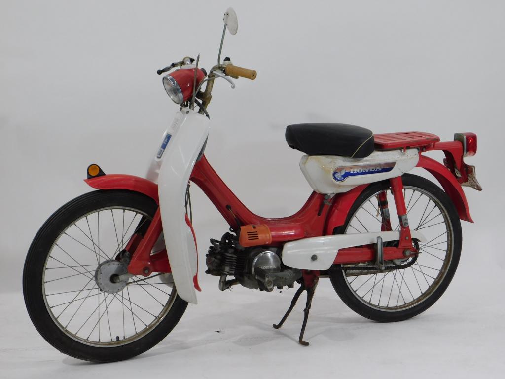 1960's Little Honda 50 CC Moped PC50EA: Japan,Circa 1960 Cross between a scooter and a motorcycle, the little Honda 50 was a small scale two wheeled revolution to the transportation industry, featuring a sporty red and white paint job. Meta