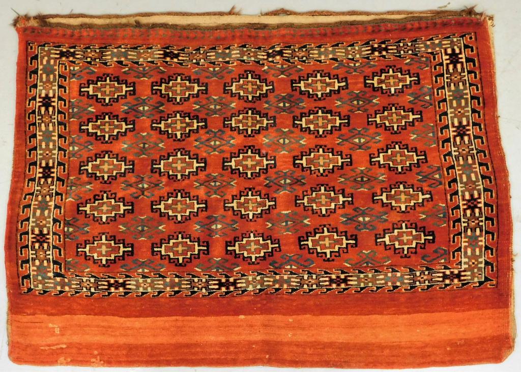 Antique Middle Eastern Bag Face Textile Rug: Middle East,Circa 1900 Repeating blue geometric pattern over red field encased by an angular geometric border. Wool, cotton,33 1/2" x 48", From the collection of a Medfield, Massachusetts gentleman.