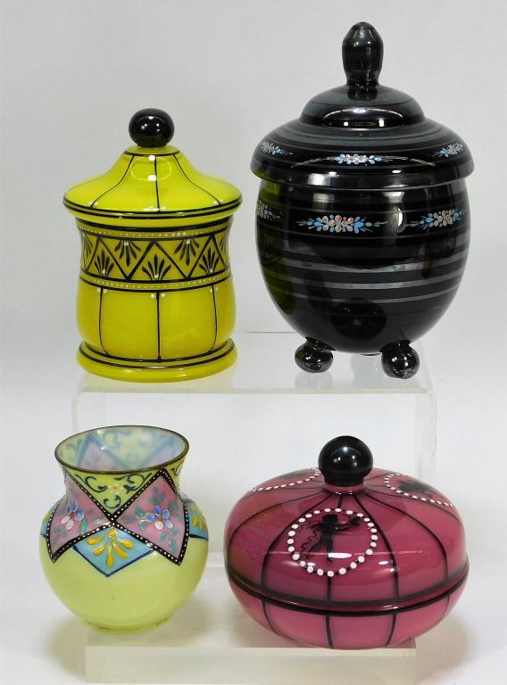 4 Assorted Enameled Bohemian Czech Art Glass: Bohemia,20th Century Lot includes one Ruckl yellow and black covered jar, one Ruckl pink covered jar decorated with puti, one black covered bowl, and one pale yellow squat vase with geometric flower d