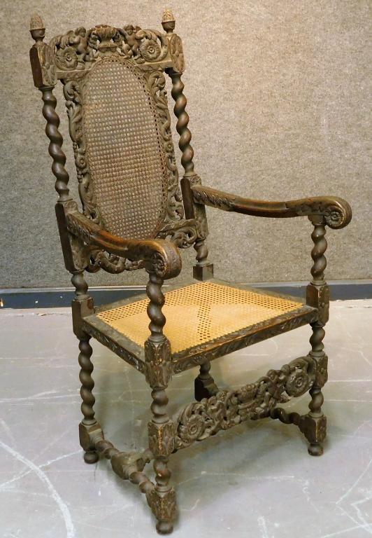 Continental Baroque Carved Wood Cane Chair: Europe,18th Century Ornately carved arm chair with acorn finials, cherubs, finely turned legs, and caned seat and backrest.Wood,49" t x 25" w x 22" d,Seat height 18"From the collection of a Cranston,