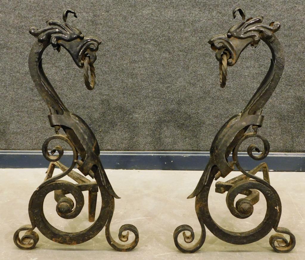 PR Figural Opposing Dragon Wrought Iron Andirons: Europe,19th Century Opposing scrolled dragon form with free rings clenched between their teeth. Iron,25 1/2" t x 13" w x 23" d, From the collection of a Medfield, Massachusetts gentleman.