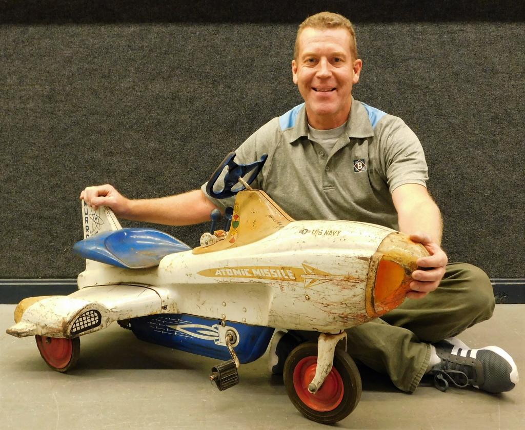 Murray Atomic Missile Airplane Space Age Pedal Car: United States,Circa 1950 Decorated with blue, white, and yellow paint with US Navy, flames, and Atomic Missile decals over the sides.Metal,24" t x 25" w x 46" d,From the collection of an Uxbridge, Mas