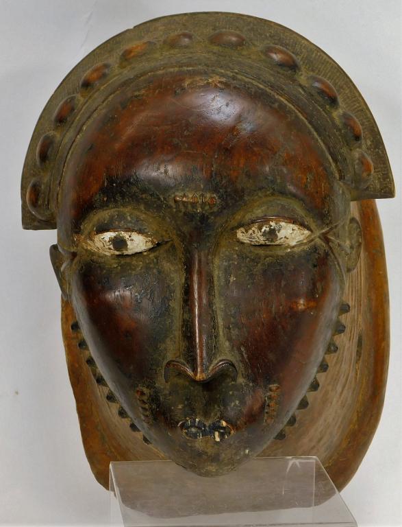 Ivory Coast Baule African Portrait Mask: Ivory Coast,20th Century Human faced mask with small mouth, long nose, and spikes along the jaw line. This mask is also known as a Goli mask and used in tribal dances and festivals.Wood,12 1/2" t x 11
