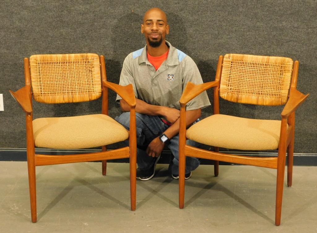 PR Attrib. Ib Kofod-Larsen Caned Winged Armchairs: Denmark,20th Century Square back over tan cushion encased by jet airplane designed flared arm rests over pierced apron and supported by four cylindrical legs.Wood, fabric,31" t x 26" w x 22" d,Seat he