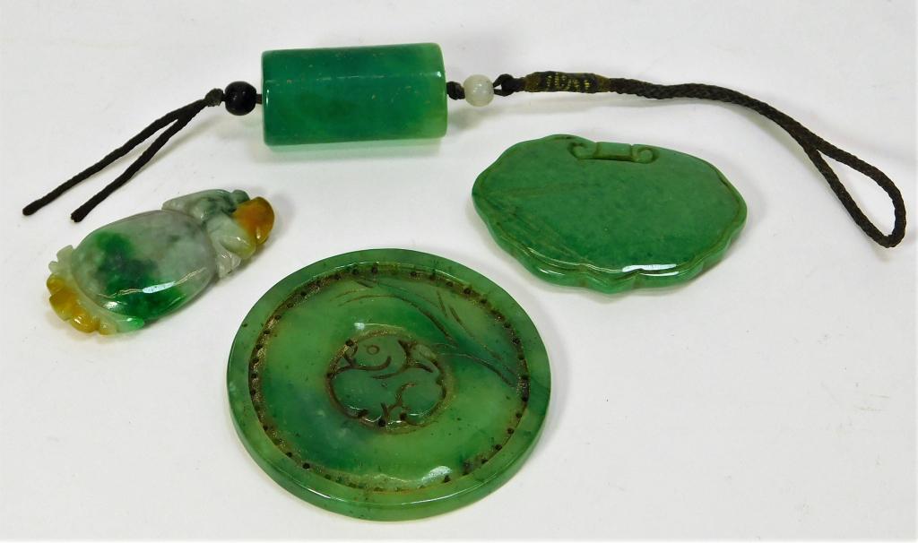 4 Chinese Apple Green Mottled Jadeite Amulets: China,Qing Dynasty Includes one carved bi disc, one bead, one carved pendant, and one white, green, and yellow mottled figural pendant. Jadeite,Smallest 1 3/4" x 7/8",Largest 2 1/4" dia. From the coll