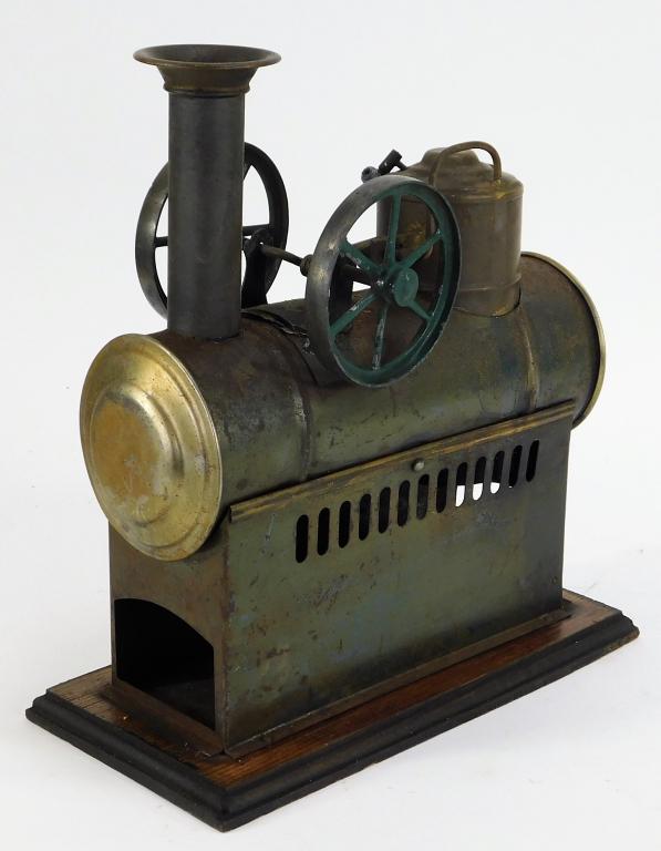 Antique German Horizontal Steam Engine: Germany,Early 20th Century Double flywheel overtype engine with oxidation over the furnace and especially on burner, flywheels retain majority of their color and the plinth has very minor wood splits.