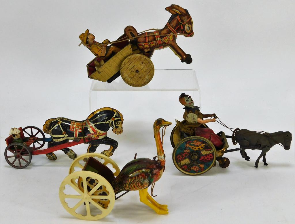 4 Antique German American Tin Animal Toy Group: United States, Germany,Early 20th Century Includes one wind up ostrich pulling a cart, one horse drawn carriage, one key wind donkey pulling a cart, and one wind up clown pulled by a donkey. Tin litho