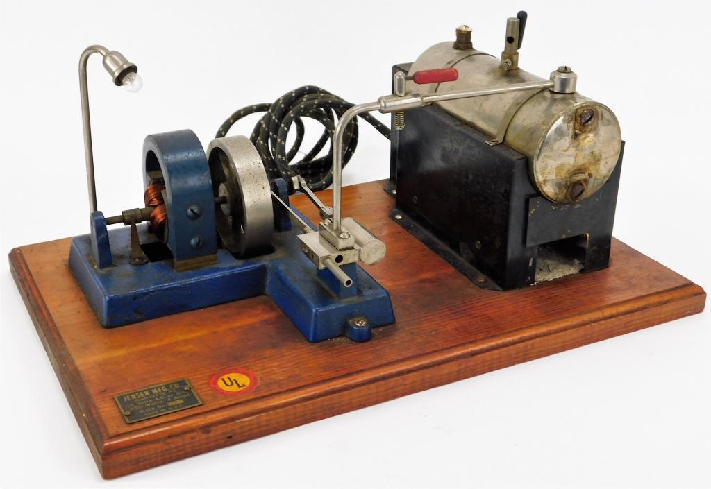 Jensen No. 10 Electric Steam Engine: United States,20th Century Horizontal engine showing signs of oxidation along boiler and furnace and other components, plinth shows light wear and is in good condition. Metal, wood,7" t x 15" w x 9 3/