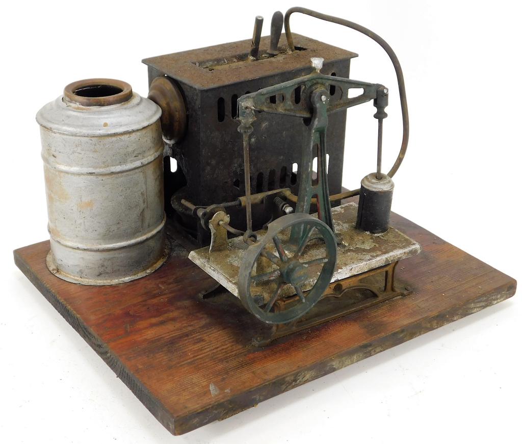 Antique German Walking Beam Steam Engine: German,20th Century Includes one original burner, oxidation especially to the furnace, some minor cracks to top of boiler, and portion of flywheel missing. Metal,7 1/2" t x 10 1/2" w x 9" d, From the