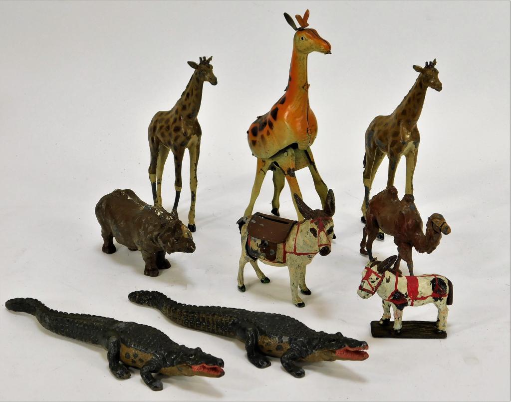 9 PC Assorted Wild Animal Cast Iron and Tin Toys: United States, England, Japan,Early 20th Century Includes two alligators with light losses to paint, one camel with slightly bent legs and some losses to paint, one rhinoceros with paint loss centered