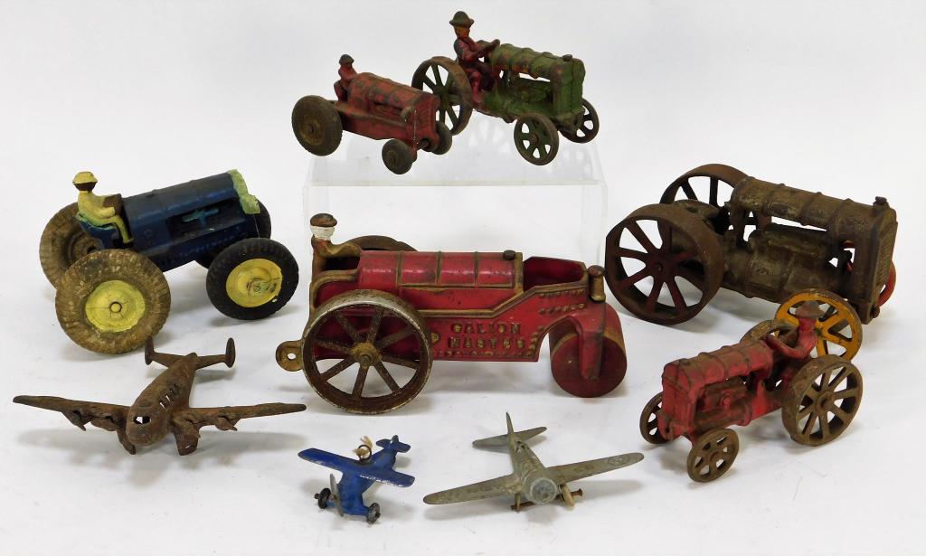 9PC Arcade Cast Iron Tractors and Plane Group: United States,Early 20th Century Includes one Kenton Galion Master steam roller with light wear to paint and oxidation focused at the wheels, one miniature Arcade tractor with moderate losses to paint
