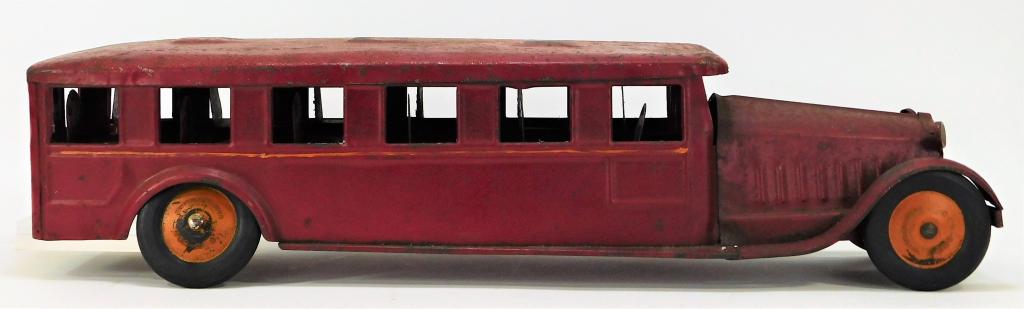 Antique Cor Cor Toys Red Pressed Steel Bus: United States,Early 20th Century Oxidation centered mainly to top of bus, one rear wheel is missing, minor scratches throughout, the tires are in good condition. Steel,6" t x 6 1/2" w x 23 1/2" d, Whe
