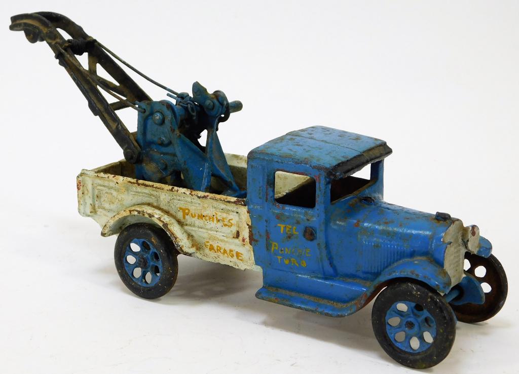 Arcade Cast Iron Toy Tow Truck: United States,Early 20th Century Blue cab with white truck bed, exhibits losses to paint around sharp edges and light oxidation throughout. Cast Iron,5 1/4" t x 3 3/4" w x 11" d, Marked "Arcade" benea
