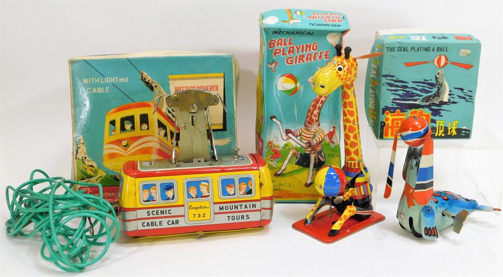 3 Cragstan Japanese Chinese Assorted Tin Toys: Japan, China,Early 20th Century Includes one seal playing with a ball wind up toy with light discoloration and scratches especially to face with original box, one ball playing giraffe with light wear 