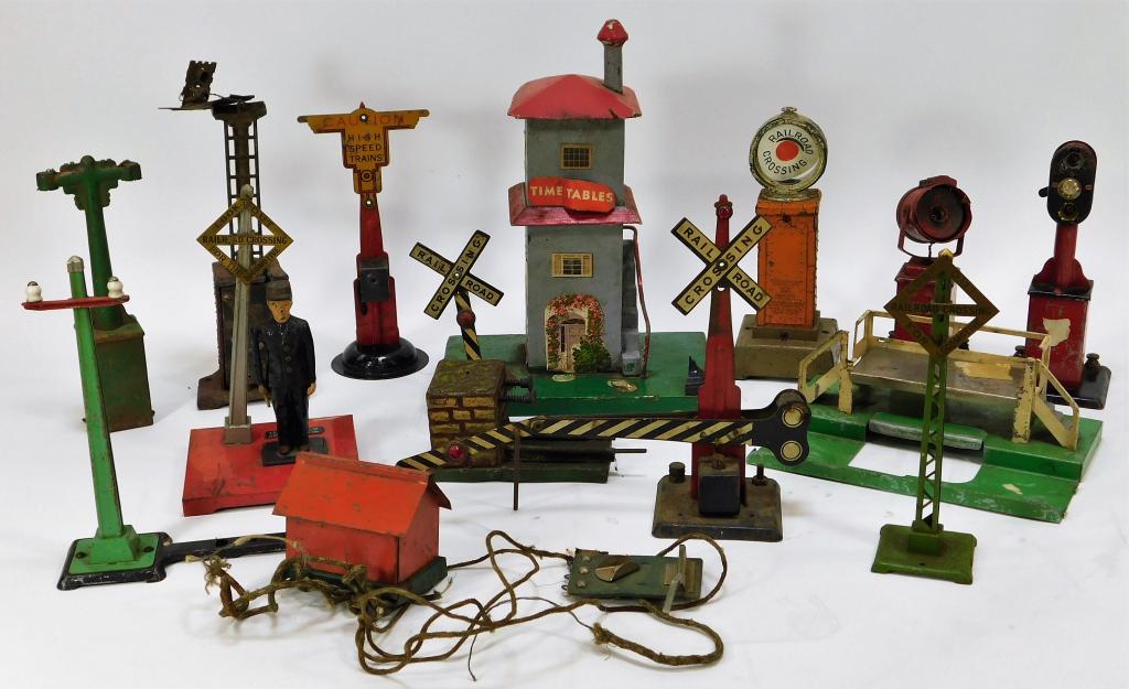 14PC Lionel Pre-war Train Station Accessories: United States,Early 20th Century Assorted larger gauge lot includes one No. 1045 flagman, four lights missing light bulbs, three railroad crossing signs, one high speed trains sign, one platform, one