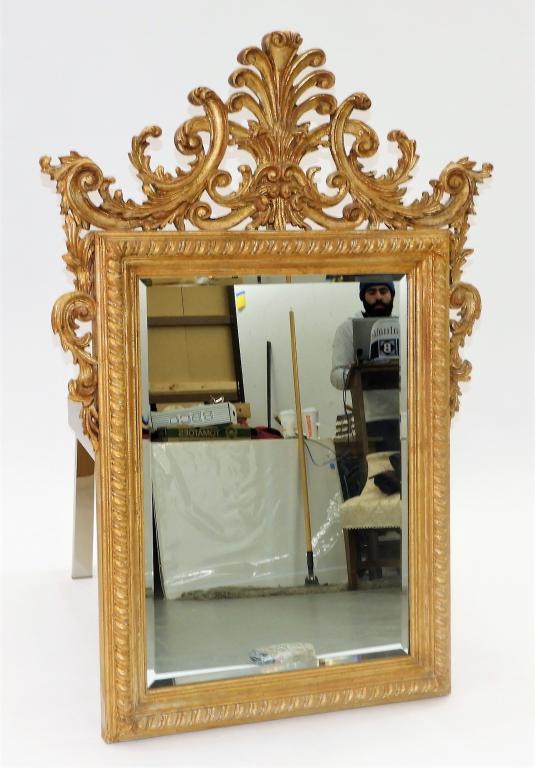 French Styled Gilt Carved Wood High Style Mirror: ,20th Century Intricate rococo styled mirror with reticulated acanthus leaf crest over a rope turned frame. Wood,55" x 38" wide, From the collection of an East Greenwich, Rhode Island lady.