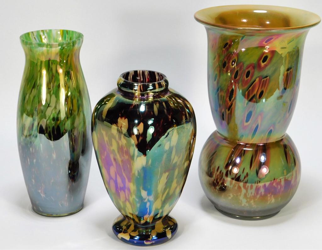 3 Kralik Iridescent Bohemian Art Glass Vases: Bohemia,Early 20th Century Lot includes one square vase with oxblood and white splatter over clear glass, one deco vase with oxblood confetti over yellow, green, and white splatter over clear glass, a