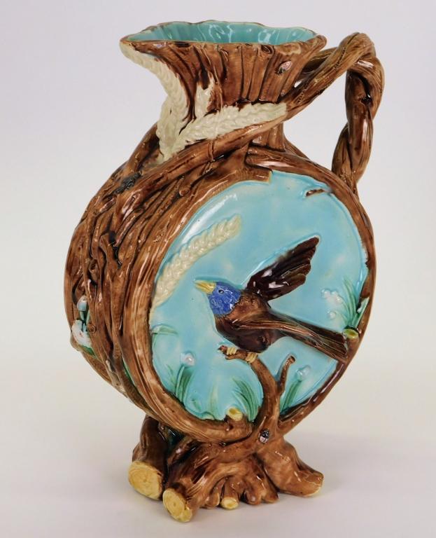 Attr. George Jones Majolica Bird and Bug Pitcher: England,Late 19th Century Drum form pitcher with bark detailing and applied birds in flight on each side with wheat and ladybugs throughout. Pottery,5 1/2" t x 13 1/2" w x 7" d, From the collection of