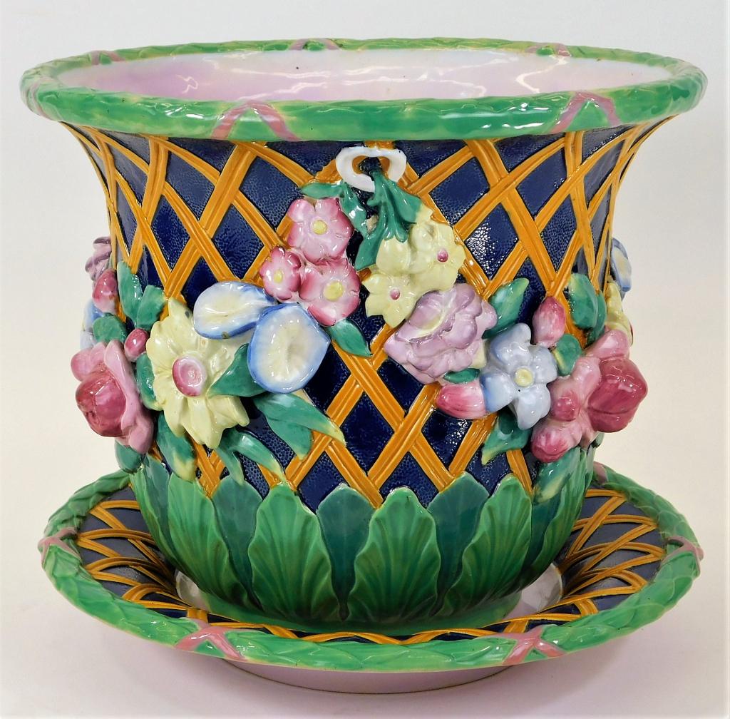 English Minton Majolica Flower Basket Jardiniere: England,Circa 1870 Large planter with lattice basket pattern over a deep blue glaze with polychromatic applied flowers resting atop a plate with matching lattice pattern. Pottery,Overall 11 1/4" x 13"