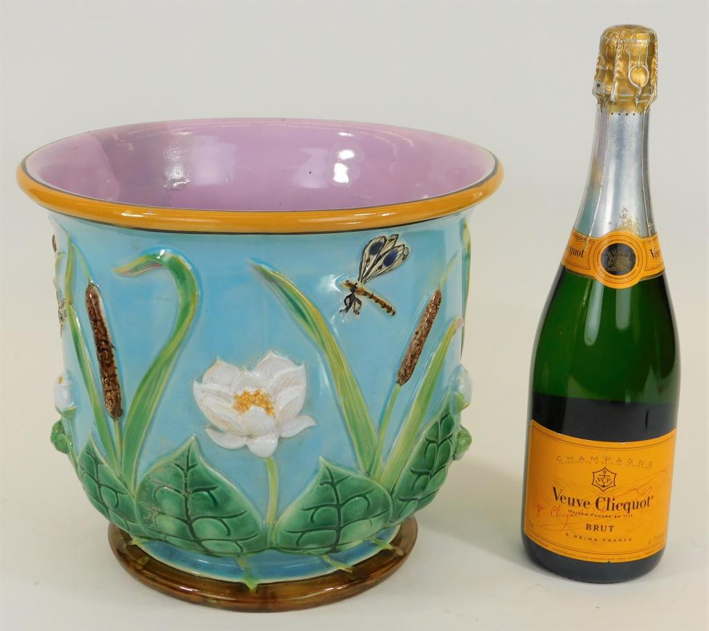 George Jones Majolica Riverside Jardiniere Planter: England,Late 19th Century Finished in a lovely powder blue glaze decorated with applied cattails, leaves, flowers, and dragonflies. Pottery,9 1/2" x 11" dia., Marked "Jones" on bottom in a half circle
