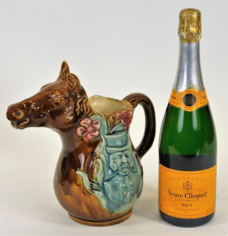 French Majolica Figural Horse Pitcher: France,Late 19th Century Brown horse headed pitcher decorated with jockey and gentlemen motifs glazed in green on each side of the body. Pottery,9 3/4" t x 9 1/2" w x 5 1/2" d, Marked "387" on bottom.