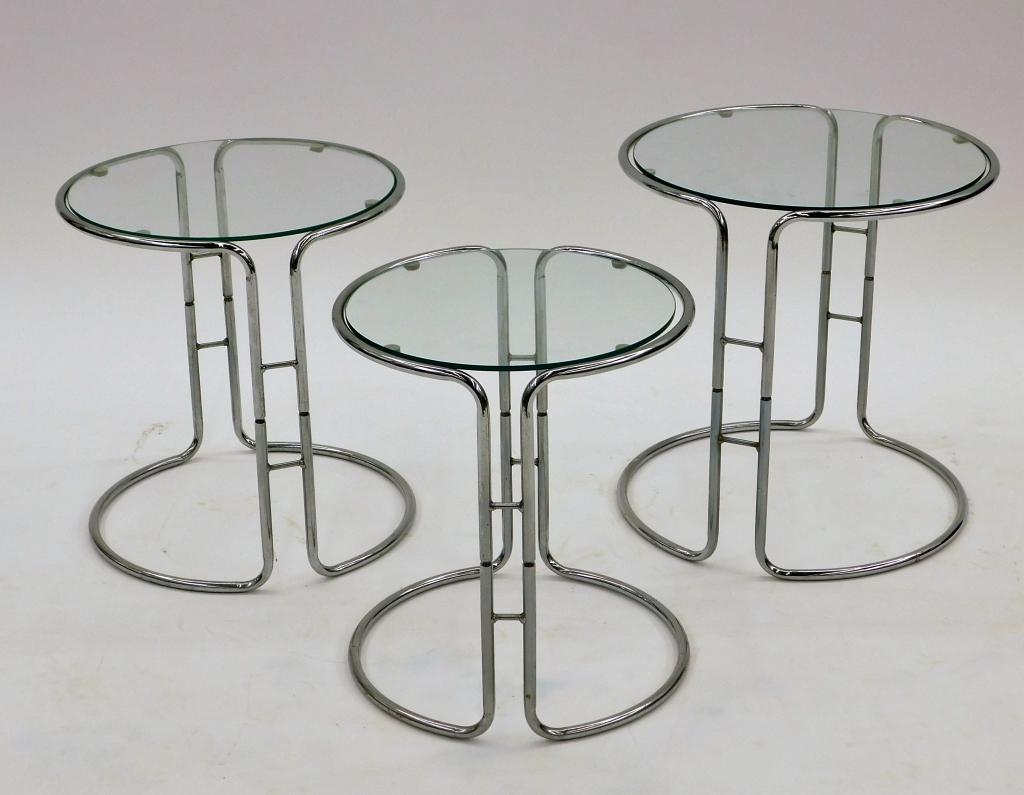 3PC Vintage Modern Chrome Glass Nesting Tables: United States,20th Century Round glass tops set in two piece chrome frames nested as one in a barrel form. Metal, glass,17 1/2" t x 17" dia., From a North Scituate, Rhode Island gentleman.