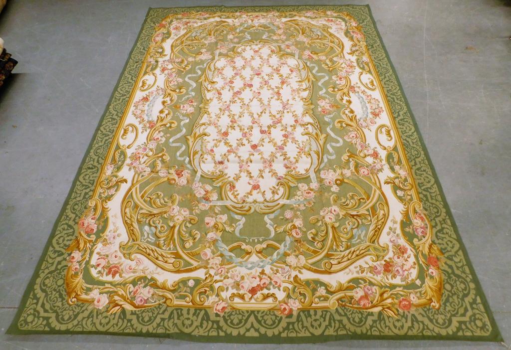 French Green Sino Aubusson Flat Weave Rug Textile: France,20th Century Delicate pink floral designs over a cream ground within gold and sage green borders. Wool,14' x 9' 9", From the collection of a Providence, Rhode Island gentleman.