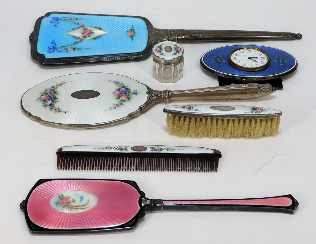 Guilloche Enamel Silver Vanity Brush Mirror Group: France, United States,Early 20th Century Includes one pale pink hand mirror decorated with roses and robins, one baby blue mirror decorated with pink roses, blue flowers, and swags coming off of a cen